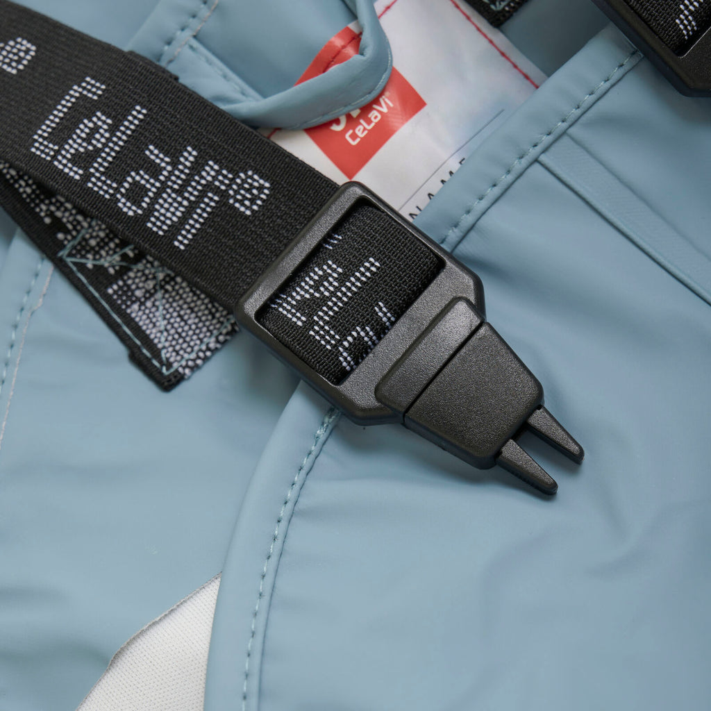 Close-up of clip on bibbed pants on kids’ waterproof rain pants in blue